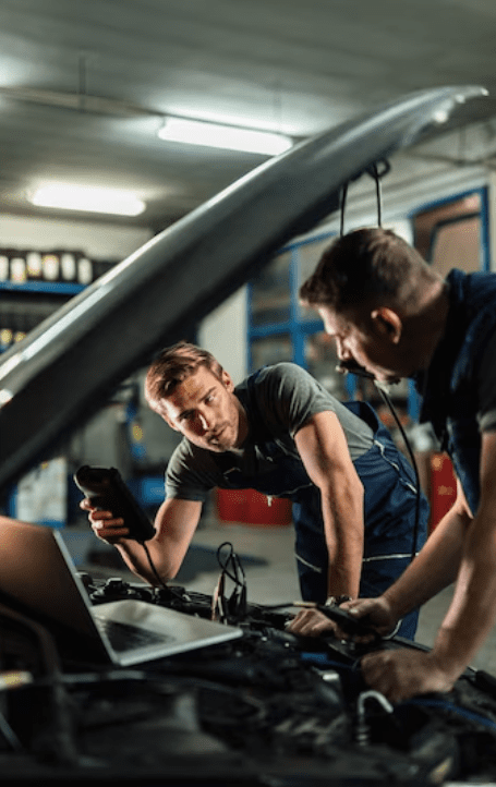 Young car repairman talking with his coworker Young car repairman talking with his coworker